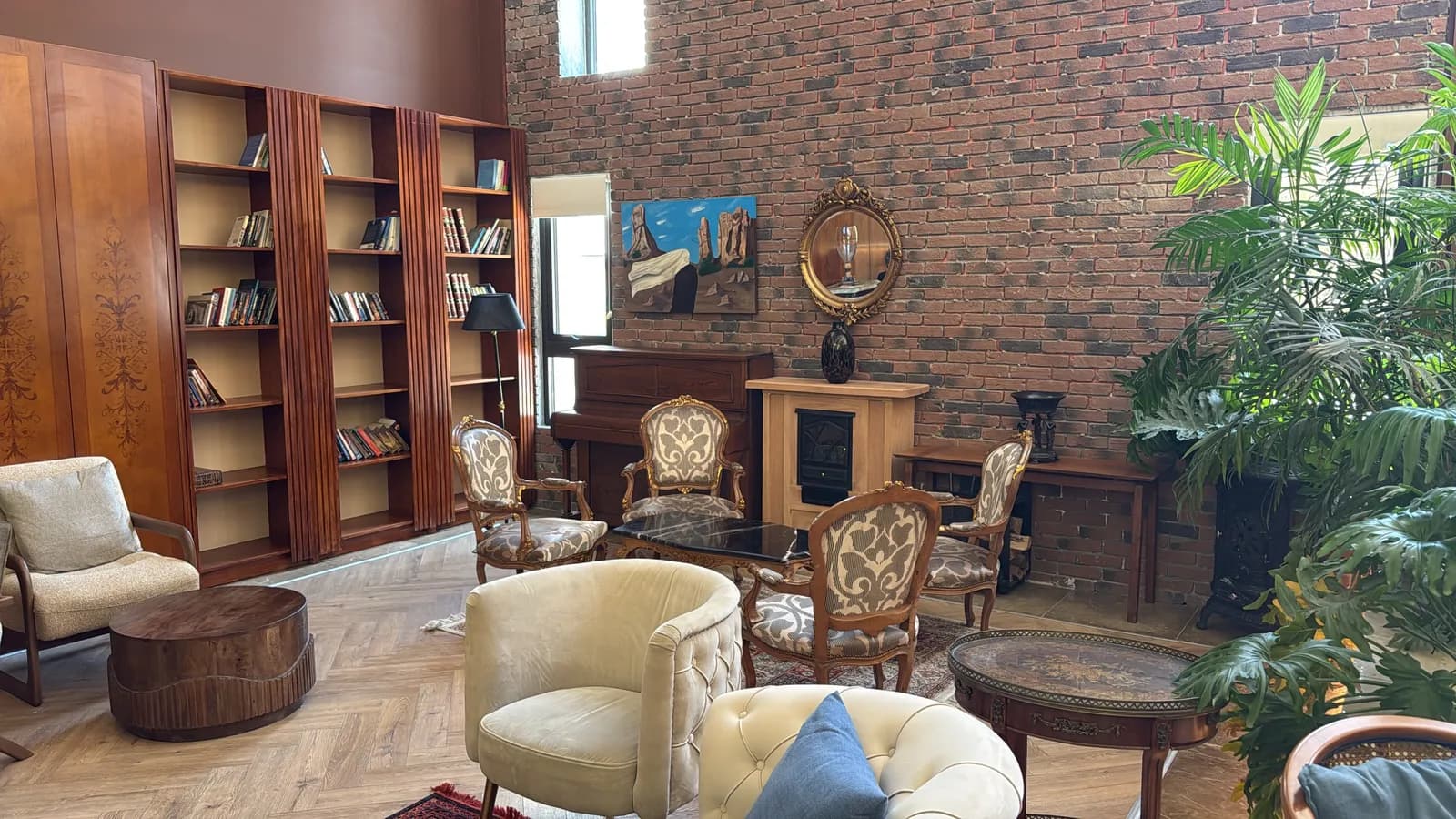 The piano room with exposed brick and fireplace